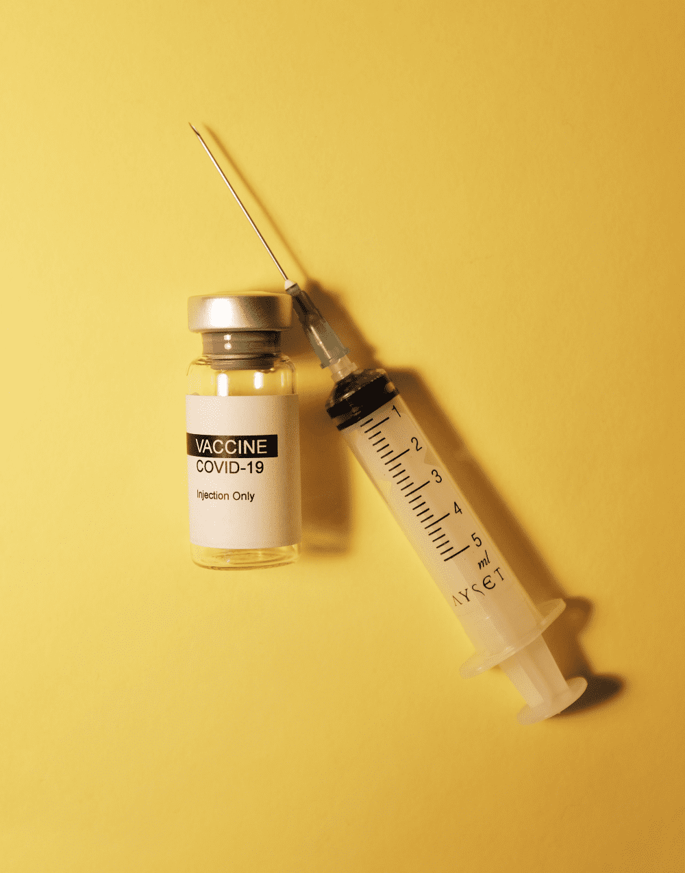 vial and syringe containing the covid-19 vaccine
