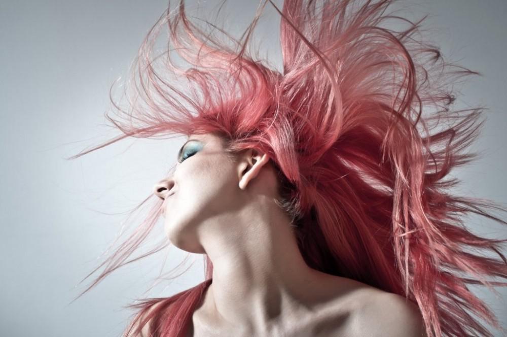 woman shaking out her long pink hair