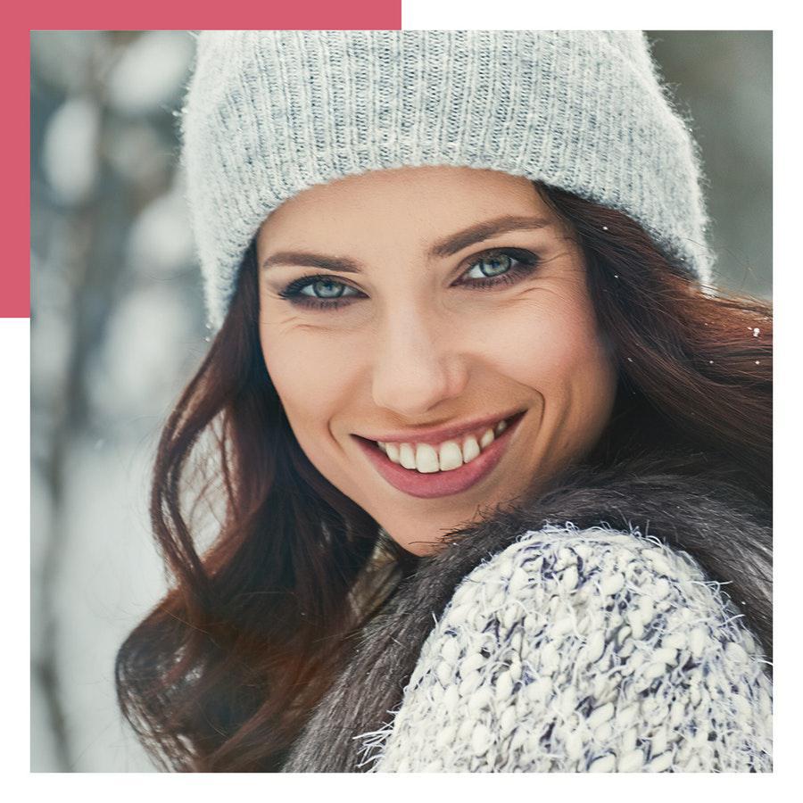 woman smiling outside in winter clothes