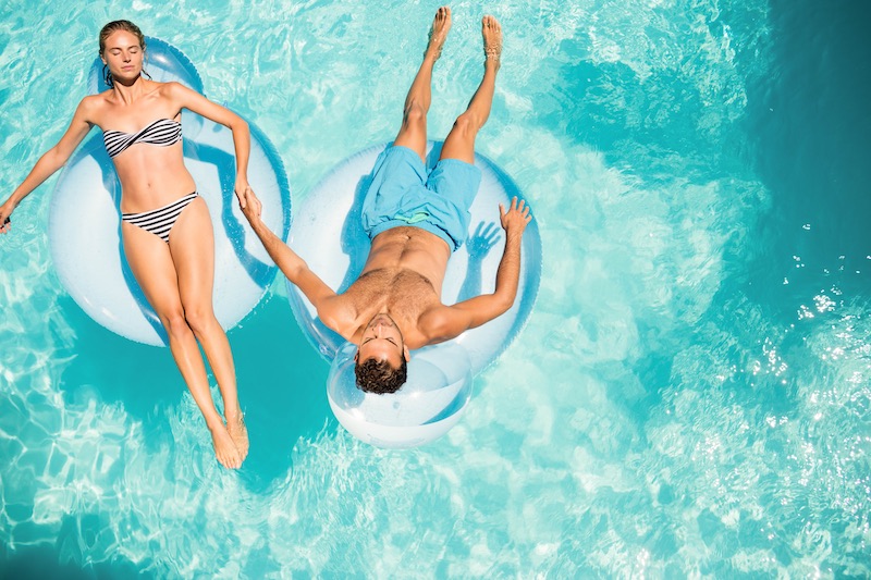 Happy couple on floats in the pool